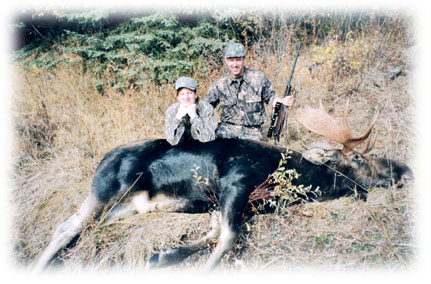 Two hunters with their large moose