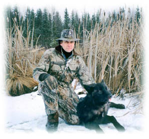 Photo of hunter with prized black wolf